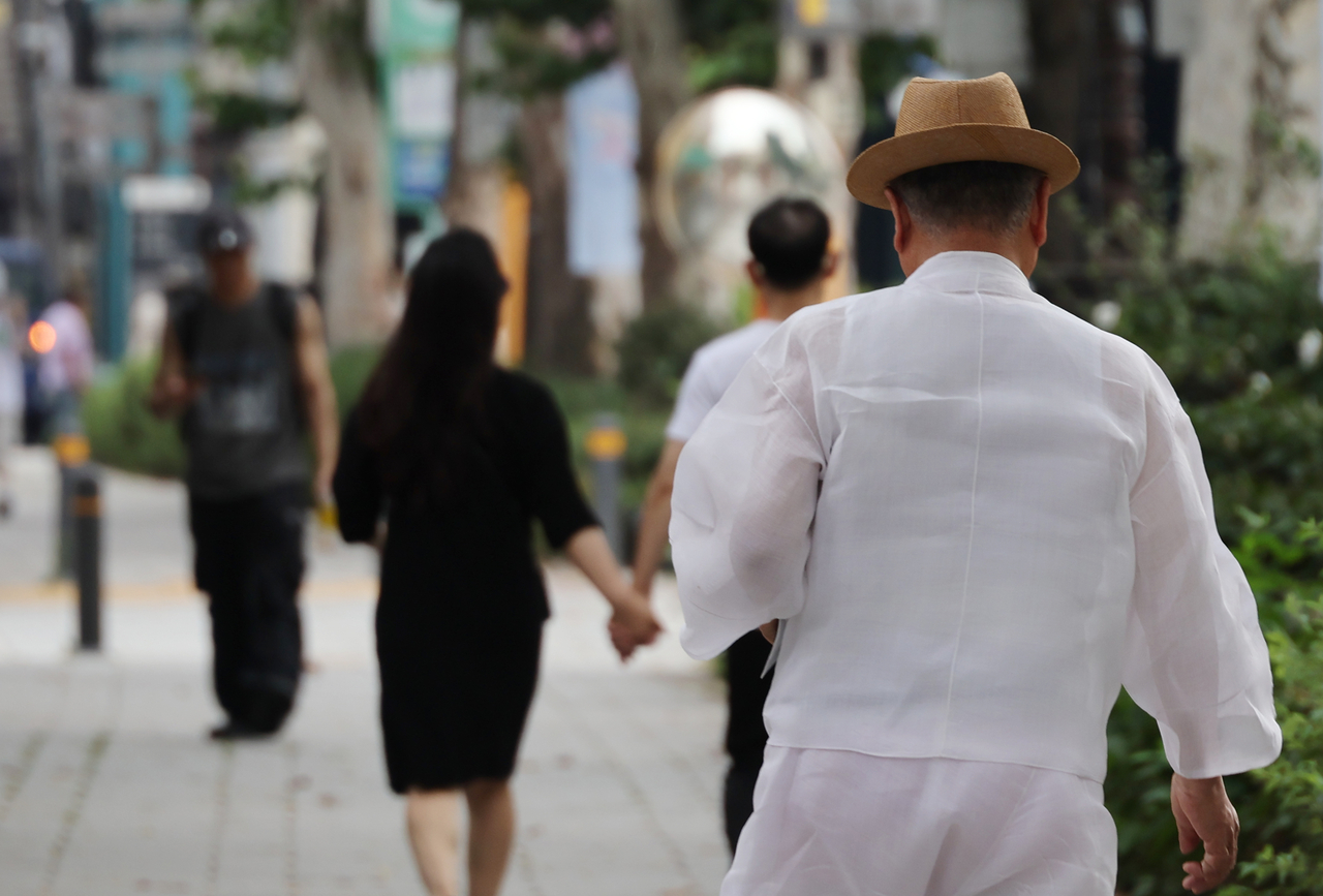 A senior citizen walks down a street. (Yonhap)